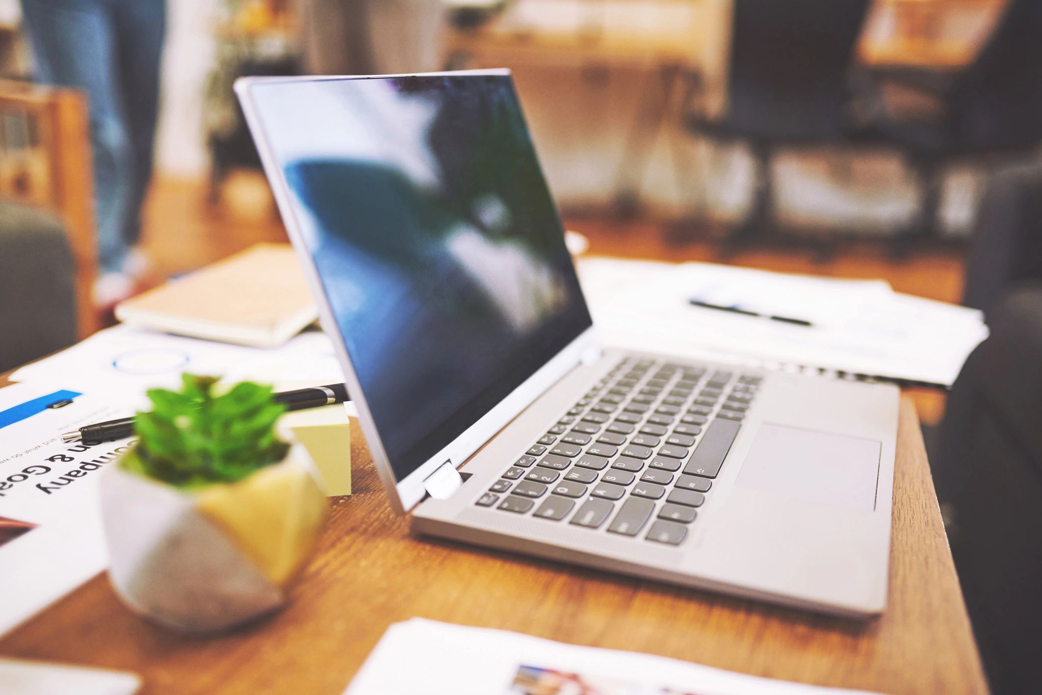 Laptop and paperwork on an office desk